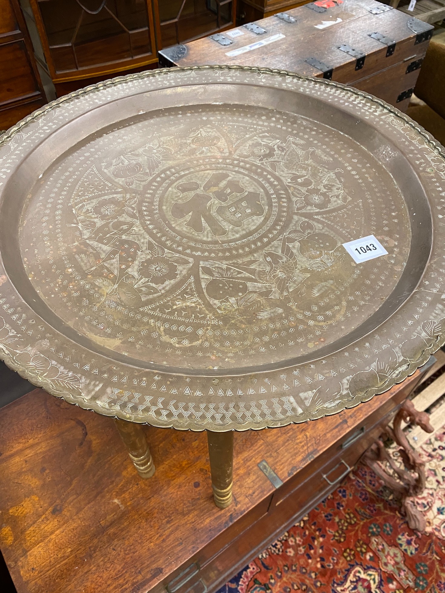 A Benares brass tray top folding table with later gold painted underframe, diameter 61cm
